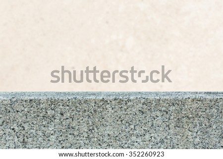 Marble table top and blurry grunge concrete cement wall with weathered dirty background for display or montage your products