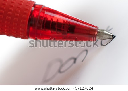 A red clear pen is writing \
