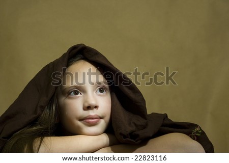 Photo of a girl with brown eyes and brown cloth over head