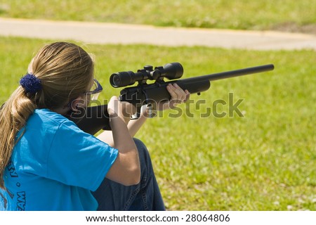Girl shooting 22 rifle at shooting sports