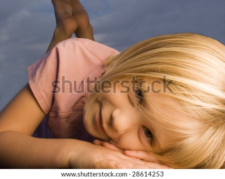 Girl laying down facing camera outside