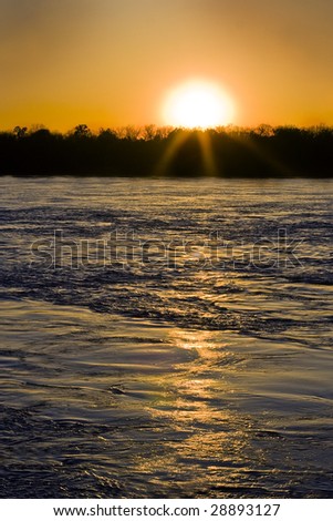 Mississippi river at flood stage with setting sun