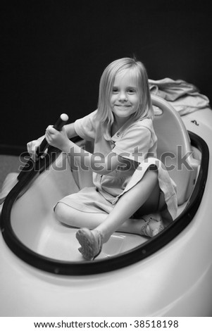 Girl in kayak rowing at science museum
