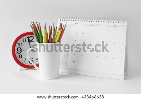 Cups, pencils,  calendars, desk clock shot in the studio.