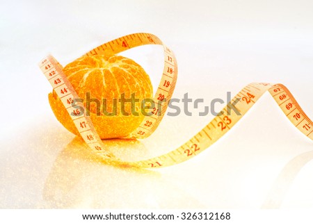 orange fruit with measure tape Diet food concept