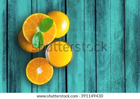 Glass of orange juice from above on vintage wood table