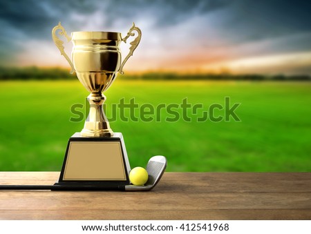 champion golden trophy on wood table with Golf clubs and golf ball