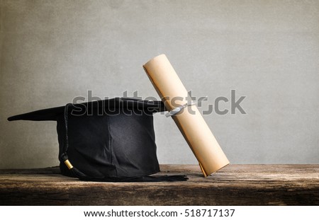 graduation cap, hat with degree paper on wood table Empty ready for your product display or montage.