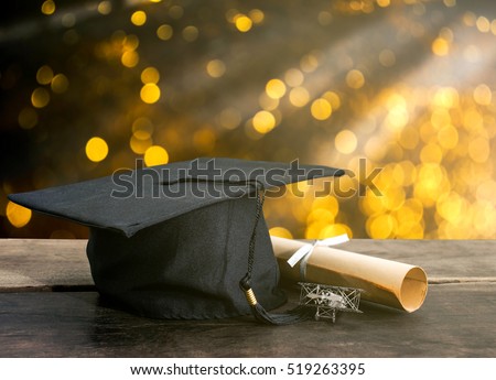 graduation cap, hat with degree paper on wood table, abstract light background Empty ready for your product display or montage.