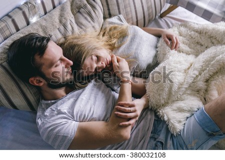 young beautiful couple embracing in bed