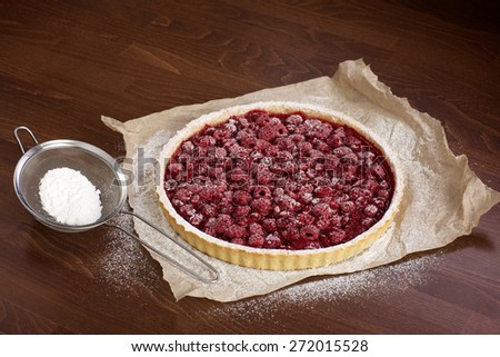 raspberry cake with icing sugar