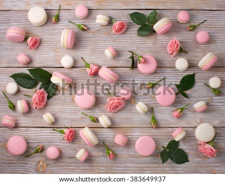 French dessert macarons pattern with rose flower. Pink and white almond cookie. Flat lay