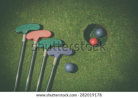 miniature golf hole with bat and ball vintage look