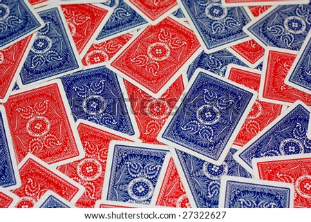 Red and blue playing cards scattered