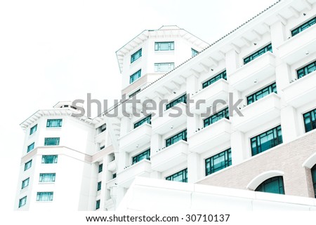 A white building with blue windows on a white background