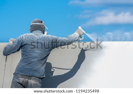 Airless Spray Painting, Worker painting on steel wall surface by airless sapray gun for protection rust and corrosion.