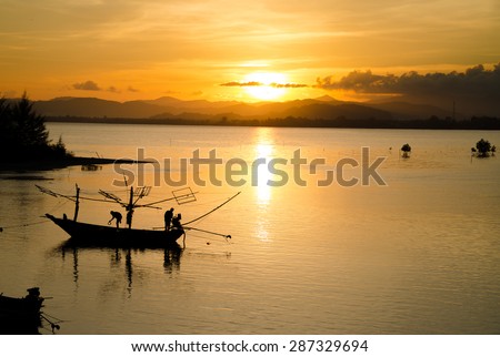 Silhouette in sunset for folkways fisherman on Mae Ramphueng bay, Thailand