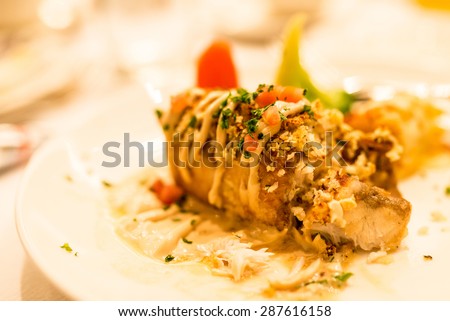 Filet of sea bass baked with crust of herbs and bread crumbs,served with lemon butter sauce.