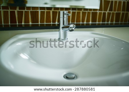 sanitary ware,a bowl for washing, typically attached to a wall and having faucets connected to a water supply; a washbasin.