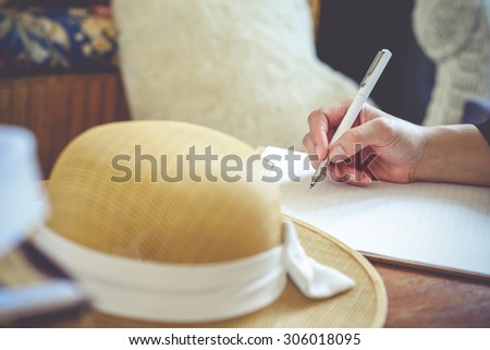 Close-up of hand holding pen and writing in diary of hand writing in diary,Vintage Style