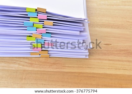 documents,Office Pile of documents with colorful clips on desk