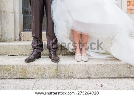 Bride and groom shoes only on boardwalk