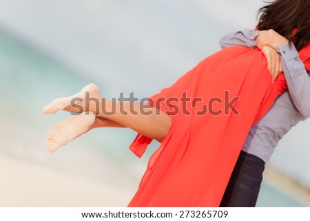 Couple together with sandy feet turquoise sea