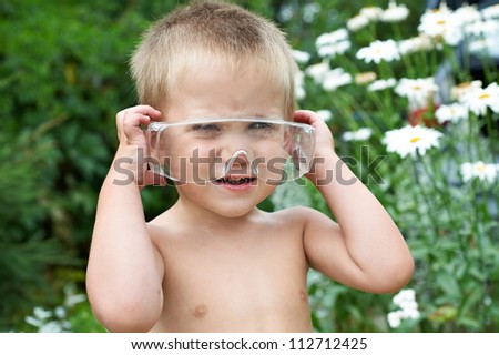 Portrait of a child in the electrical safety protection glasses