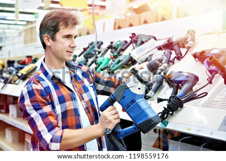 Man shopping for perforator in hardware store close-up