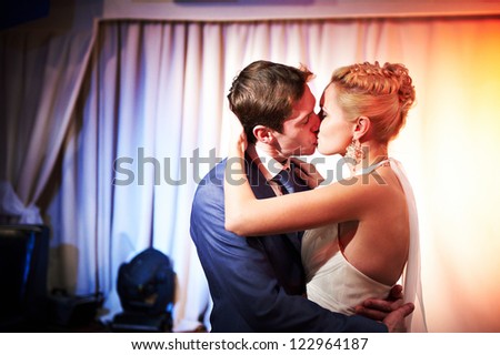 Kiss bride and groom on wedding dance
