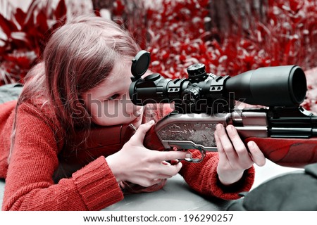 Girl aiming a pneumatic gun. Sport shooting