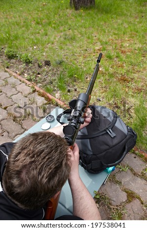 Rifle shooting with optical sight outdoors
