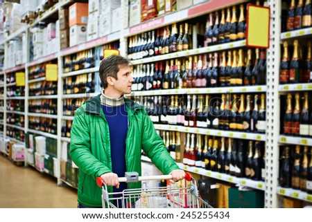 Man choosing wine in supermarket