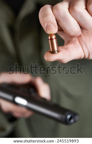 Soldier shows the cartridge from the gun closeup