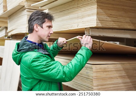 Man shopping for plywood in DIY shop