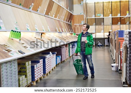 Man shopping laminate in DIY shop for construction