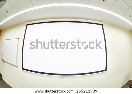 Conference room with empty projector screen