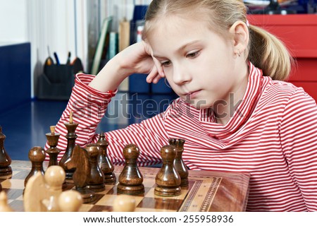 Girl thinking in a chess game