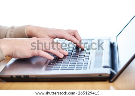 Female hand on laptop keyboard closeup