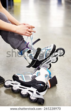 Woman wears roller skates in the sports shop