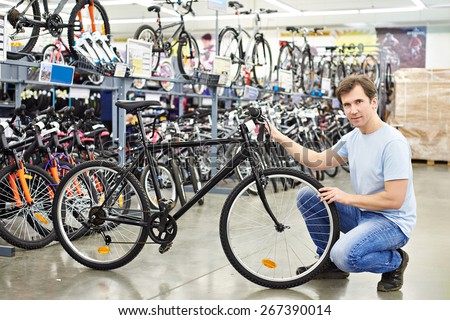 Man checks a bike before buying in the sports shop