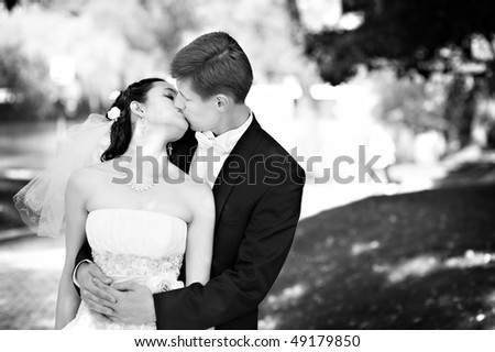 Romantic kiss the bride and groom at the wedding walk