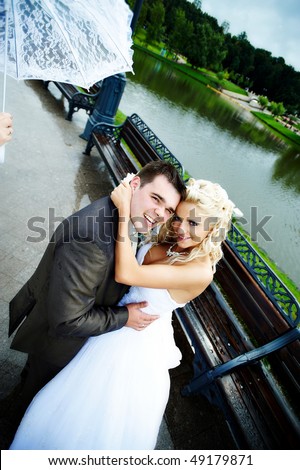 Happy bride and groom at wedding walk in the park