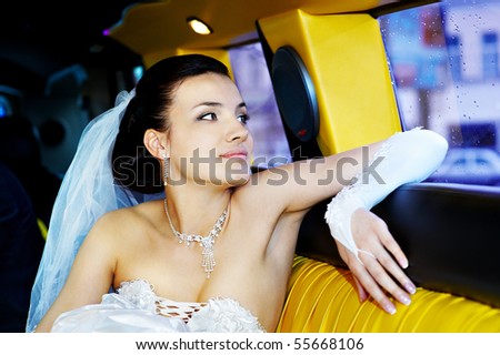 Beauty and glamour bride in yellow wedding limousine