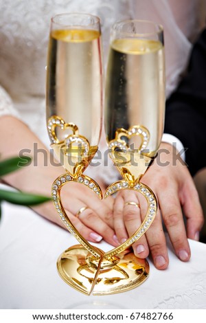 stock photo Wedding champagne glasses and bride and groom hands with rings