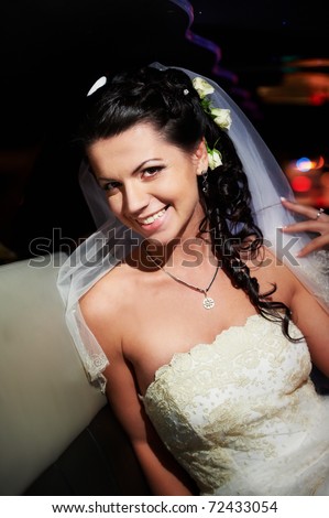 Beauty and glamour bride in wedding limousine