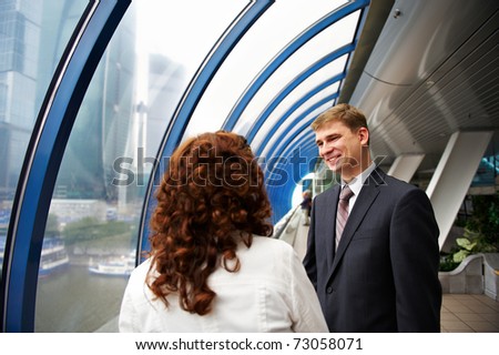 Successful business partners at a meeting at a window overlooking the trade center