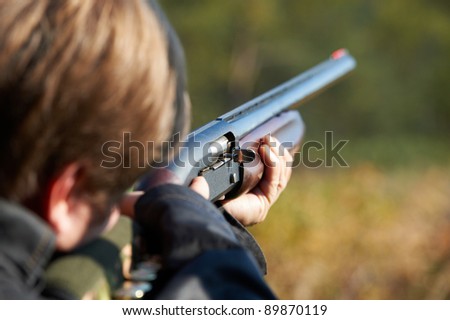 Shooter takes aim for a shot from rifle