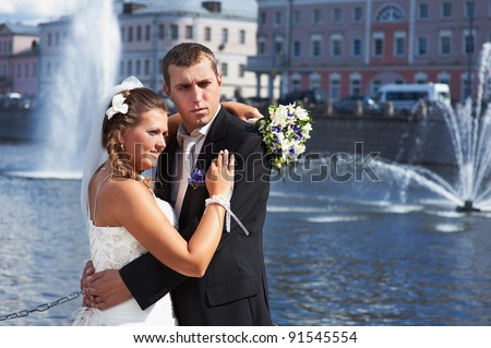 Bride and groom and fountains in river on wedding walk
