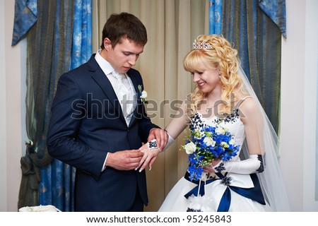 Elegant groom wears wedding ring happy bride. Solemn registration of marriage.